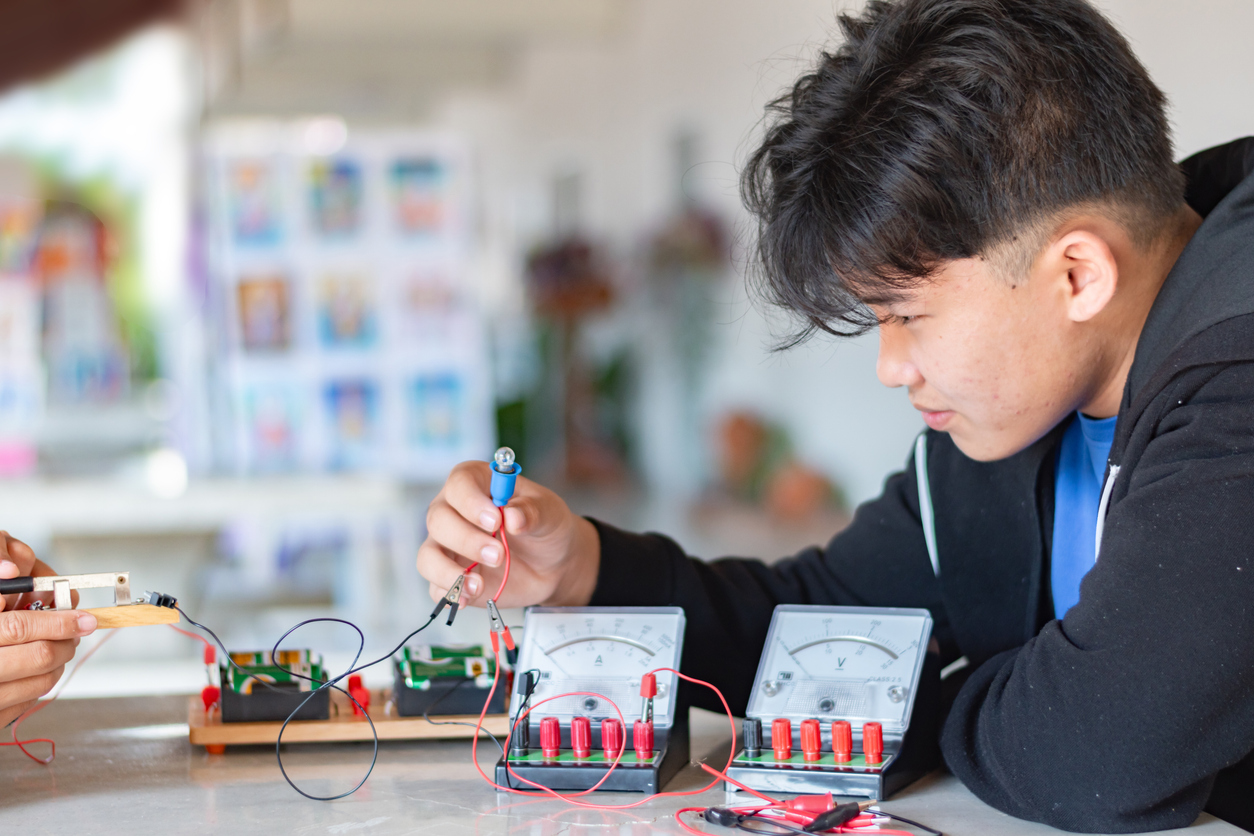 Élève du secondaire explorant des circuits électriques.
