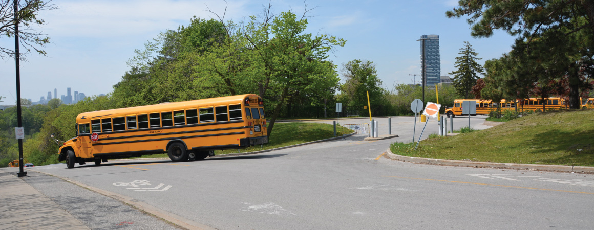 School bus departing the South Parking Lot onto Gateway Blvd. heading toward the rear entrance to the Science Centre.