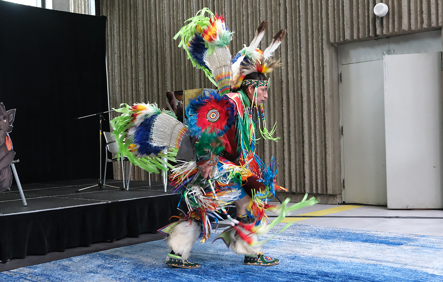 performance by an Indigenous dancer dressed in his regalia