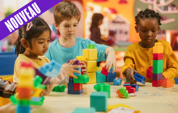 Trois enfants jouent avec des blocs de construction.